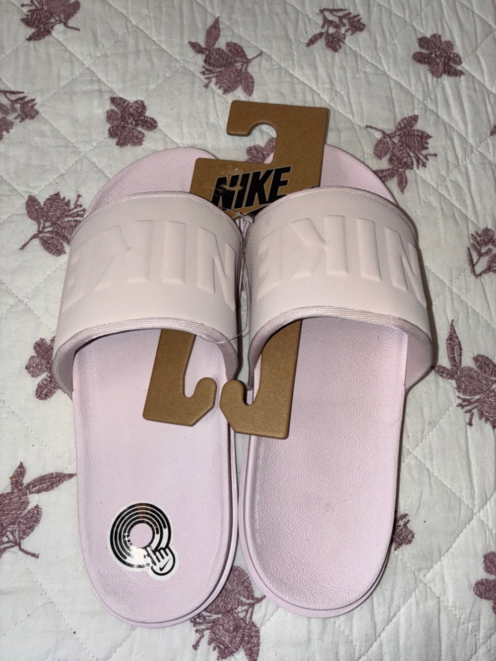 Nike Light Pink Slide Sandals with Embossed Logo